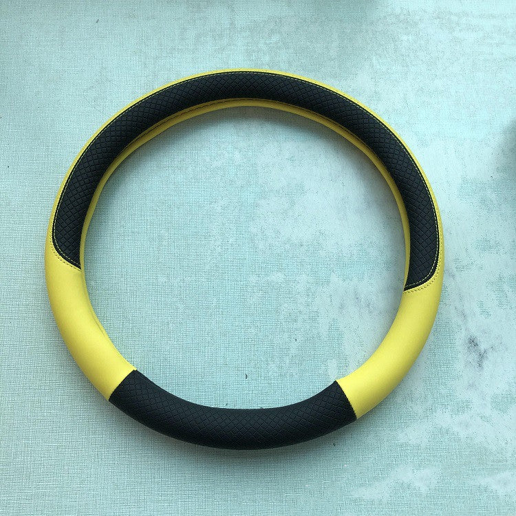Leather-look steering wheel cover, 38cm – yellow and black cover laid flat on a table