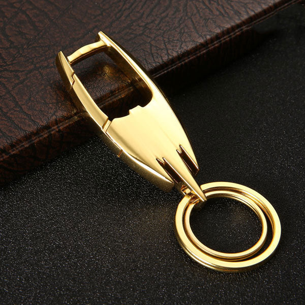 Stainless steel car key ring – close-up of gold keyring on a book