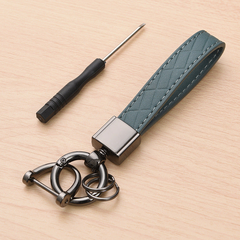 Metal car keyring with lanyard loop – teal version shown with screwdriver tool