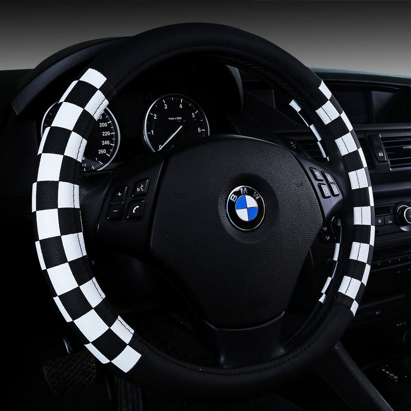 Chequered leather-look steering wheel cover, 38cm – fitted on a BMW steering wheel, black and white chequered close-up