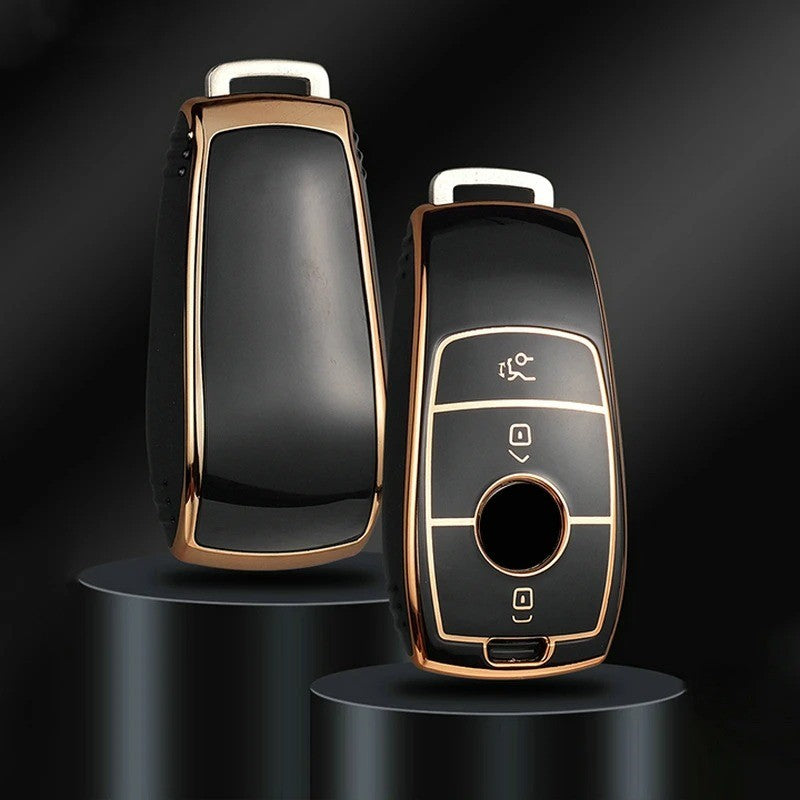 Key fob cover for Mercedes-Benz smart keys – TPU – front and back view on display stands, black with gold trim