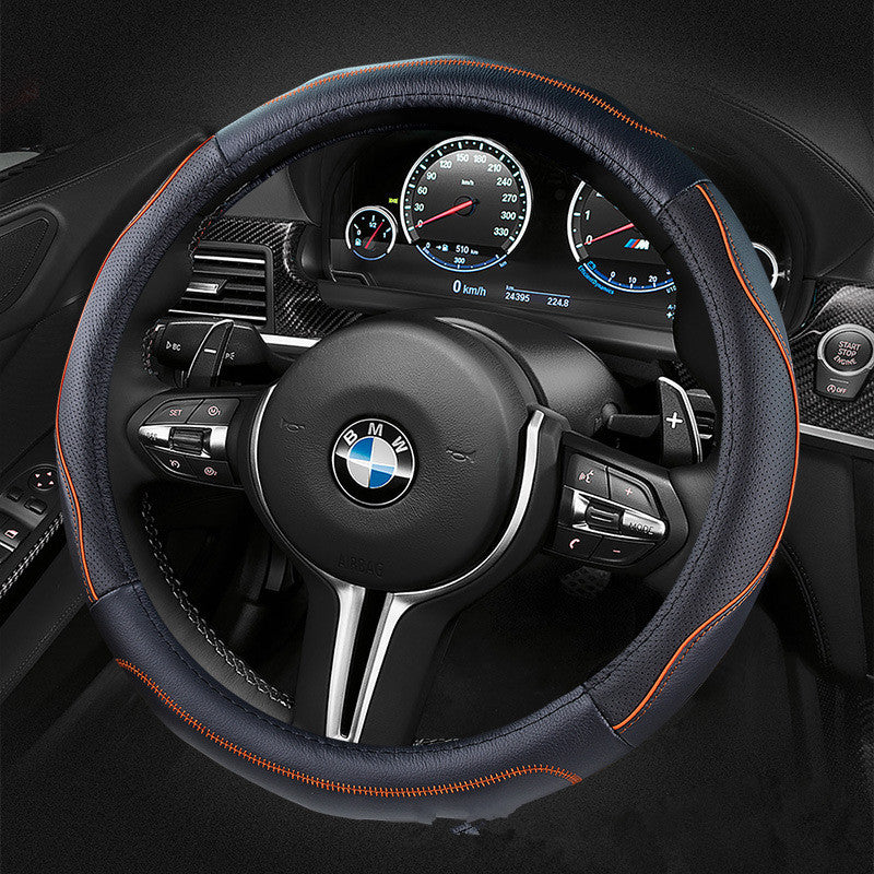 Soft-grip steering wheel cover, 36cm or 38cm – black cover with orange stitching on a BMW steering wheel