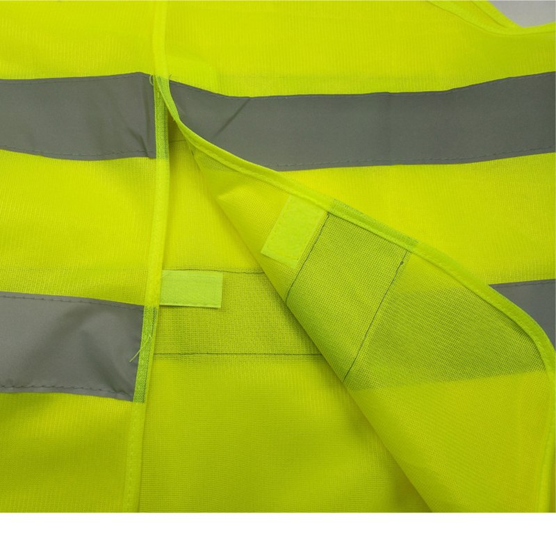 High-visibility yellow reflective safety vest – close-up of hook-and-loop fastening strips