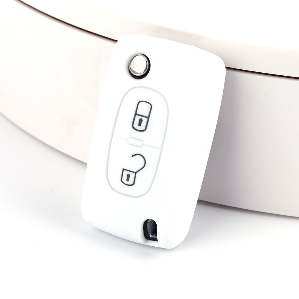 Key fob cover for Peugeot 2-button folding keys – silicone – white silicone cover on white surface