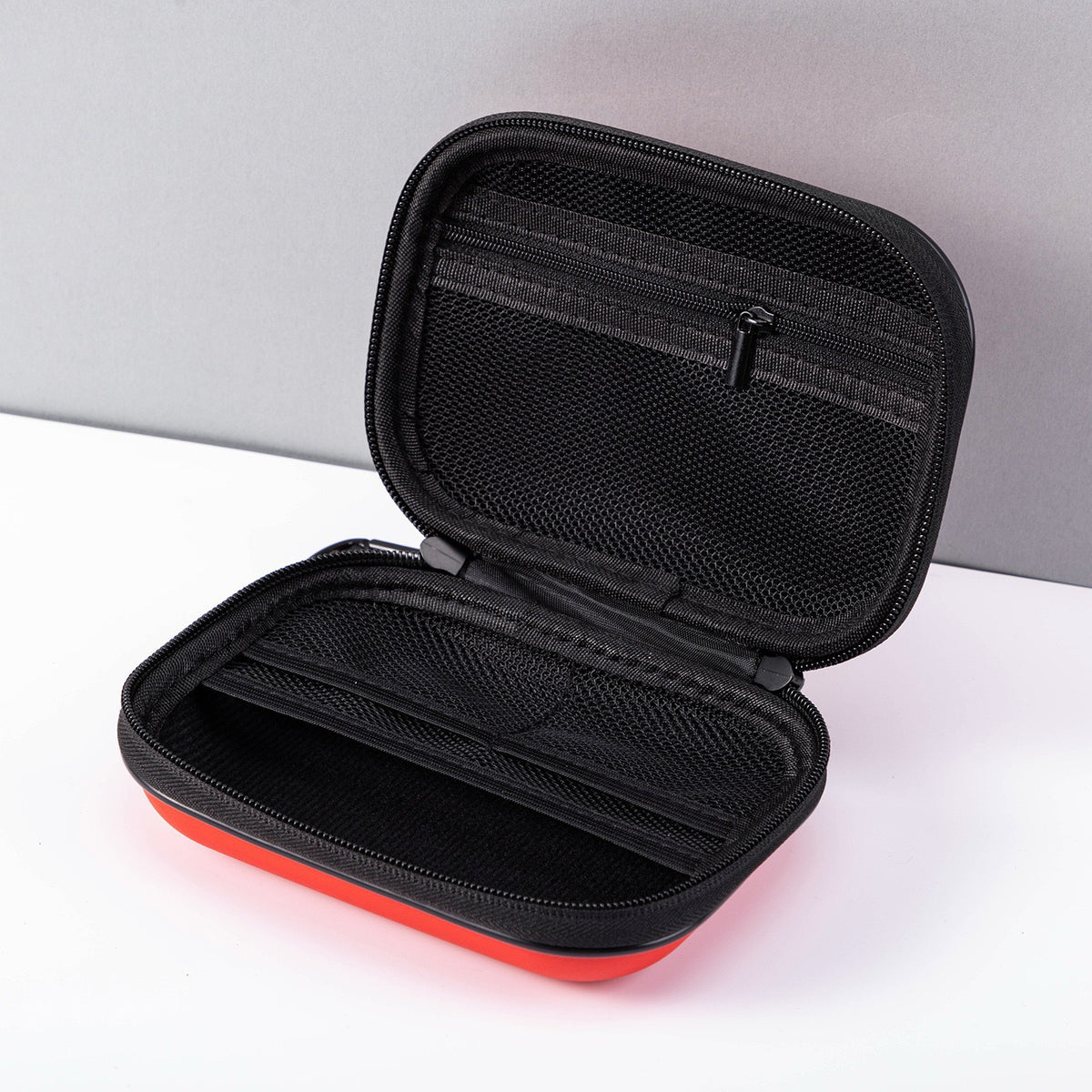 Car first aid kit in hard-shell case – open case showing mesh zip pockets inside