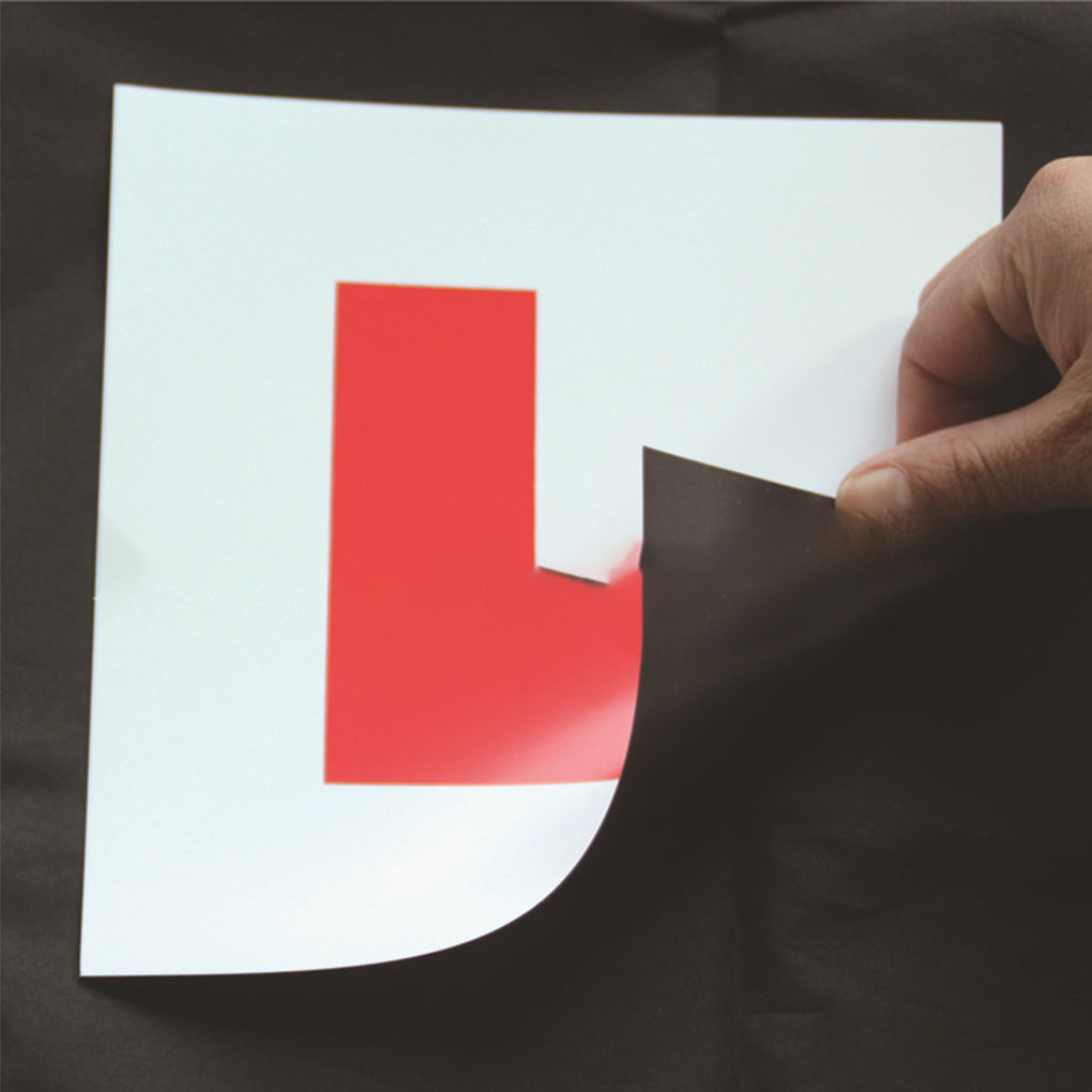 Magnetic L plates for learner drivers, 178mm – peeling back plate to reveal magnetic backing