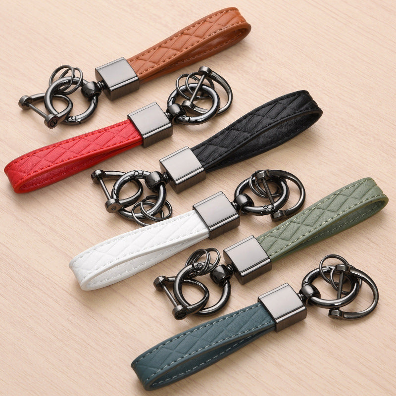 Metal car keyring with lanyard loop – six colours laid out together on wood surface