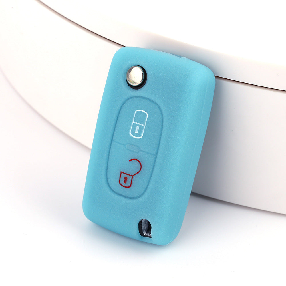 Key fob cover for Peugeot 2-button folding keys – silicone – light blue silicone cover on white surface