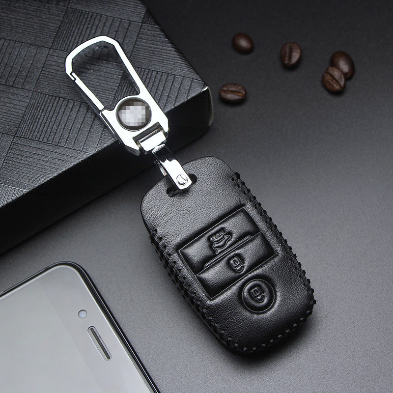 Key fob case for Kia smart & folding keys – genuine leather – black leather case with keyring and smartphone nearby