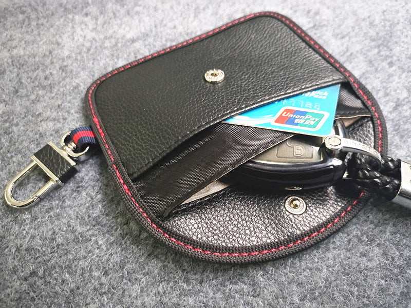 RFID signal-blocking car key case – leather or carbon-look – open case showing key fob and cards inside