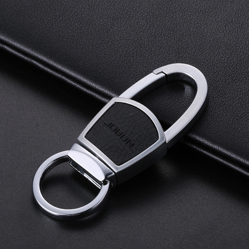 Metal chain car keyring – silver keyring with black leather panel on a book