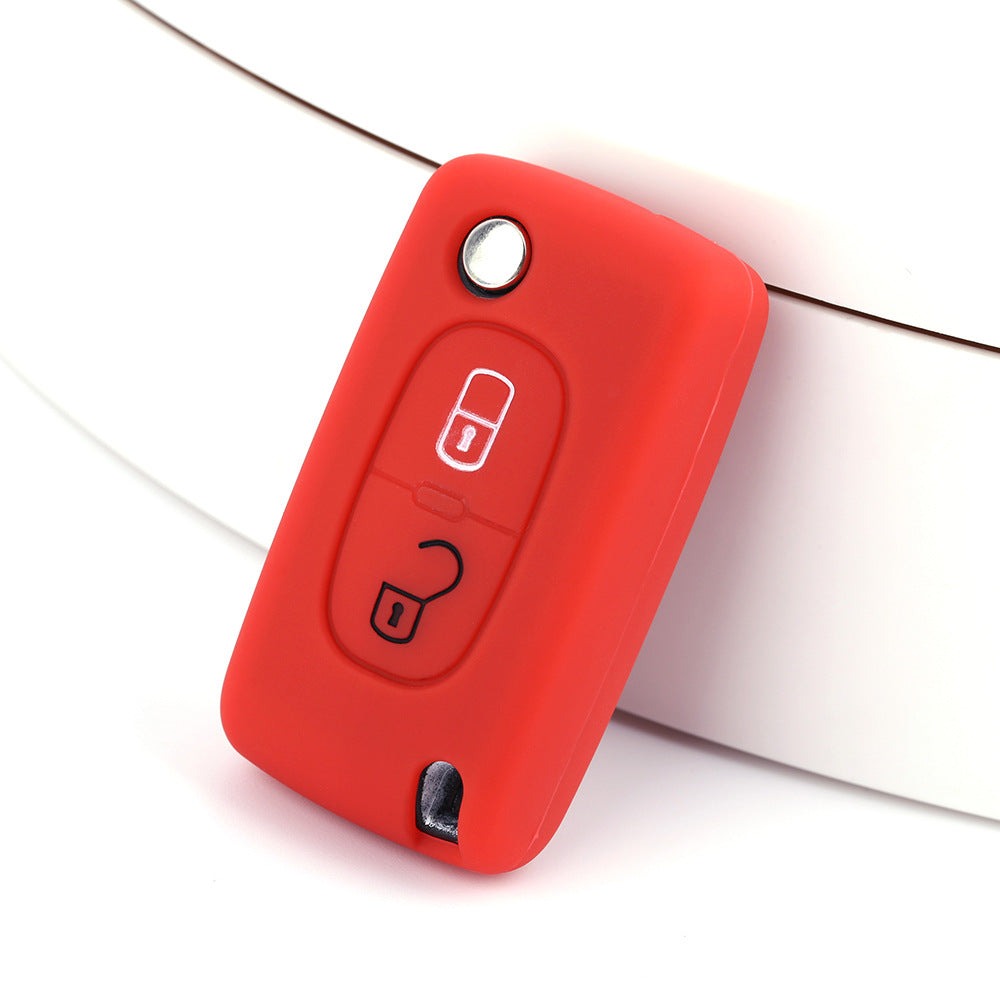 Key fob cover for Peugeot 2-button folding keys – silicone – red silicone cover on white surface
