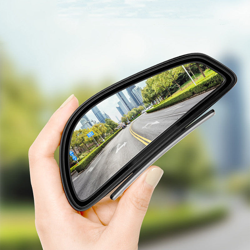 Car wide-angle reversing auxiliary mirrors – held in hand showing road reflection