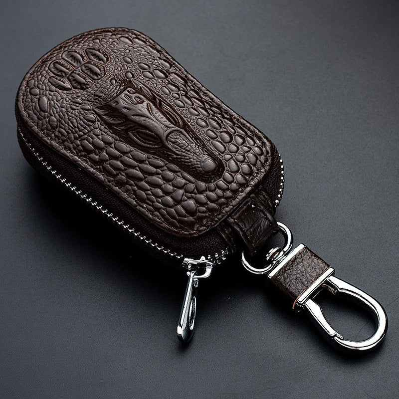 Genuine leather car key case – universal fit – dark brown crocodile-pattern case with clip on dark background