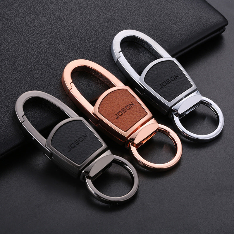 Metal chain car keyring – three colour variants of leather and metal keyrings on a book