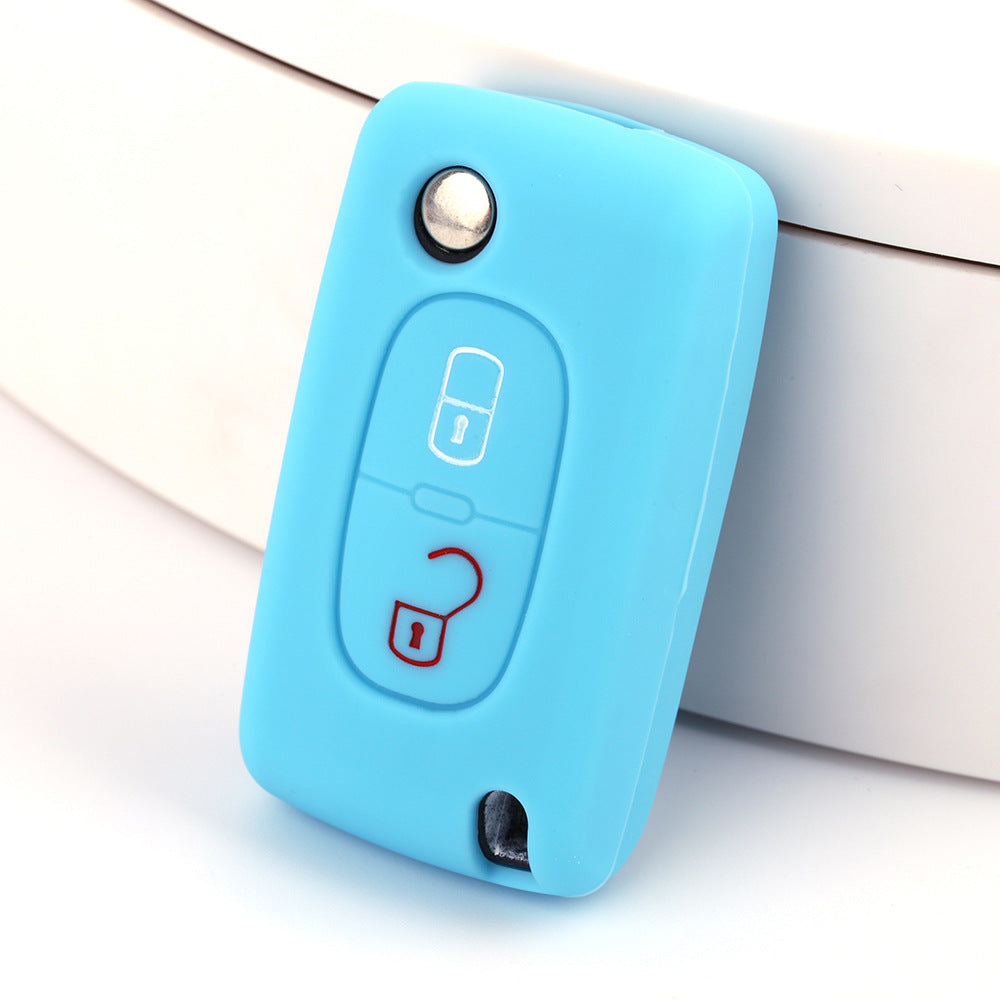 Key fob cover for Peugeot 2-button folding keys – silicone – sky blue silicone cover on white surface