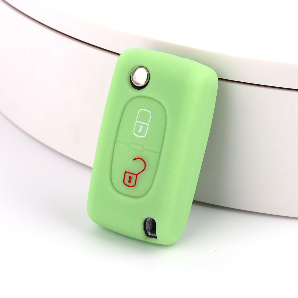 Key fob cover for Peugeot 2-button folding keys – silicone – green silicone cover on white surface